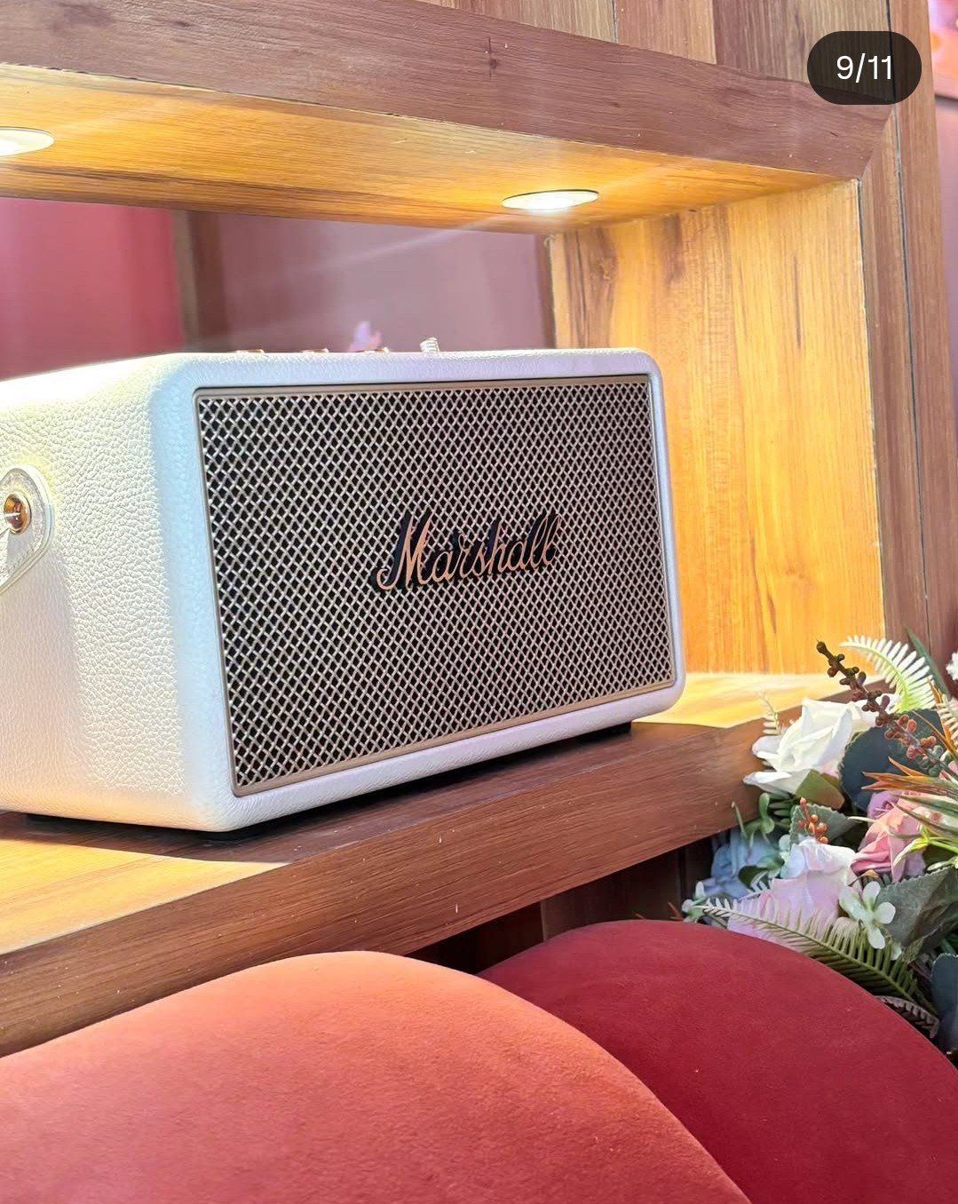 Vintage speaker on a wooden shelf with flowers