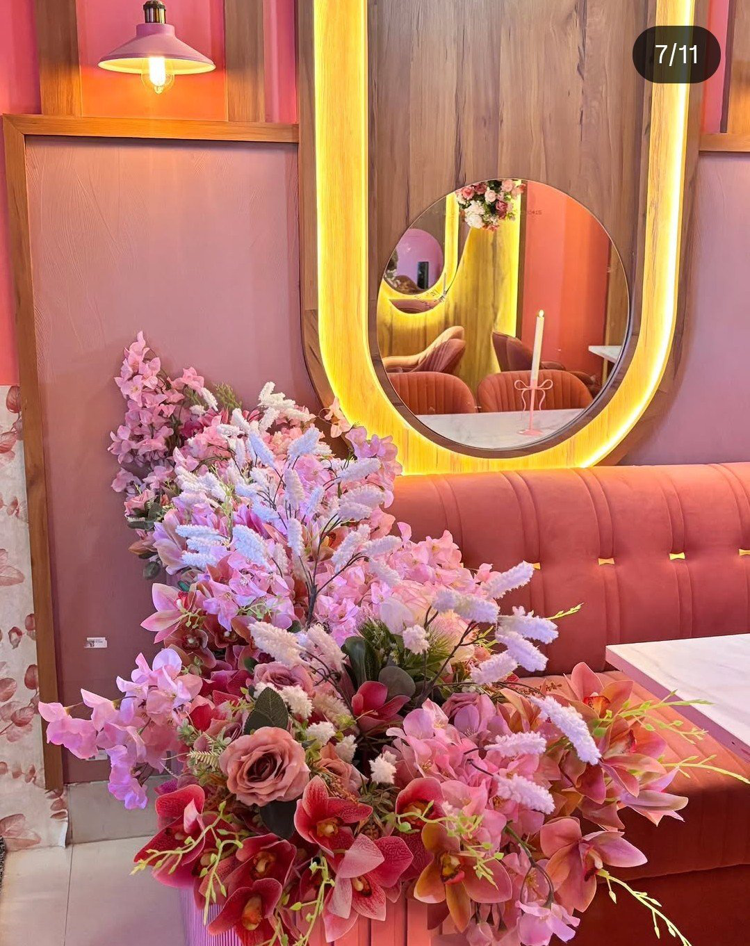 Family booths under pink neon